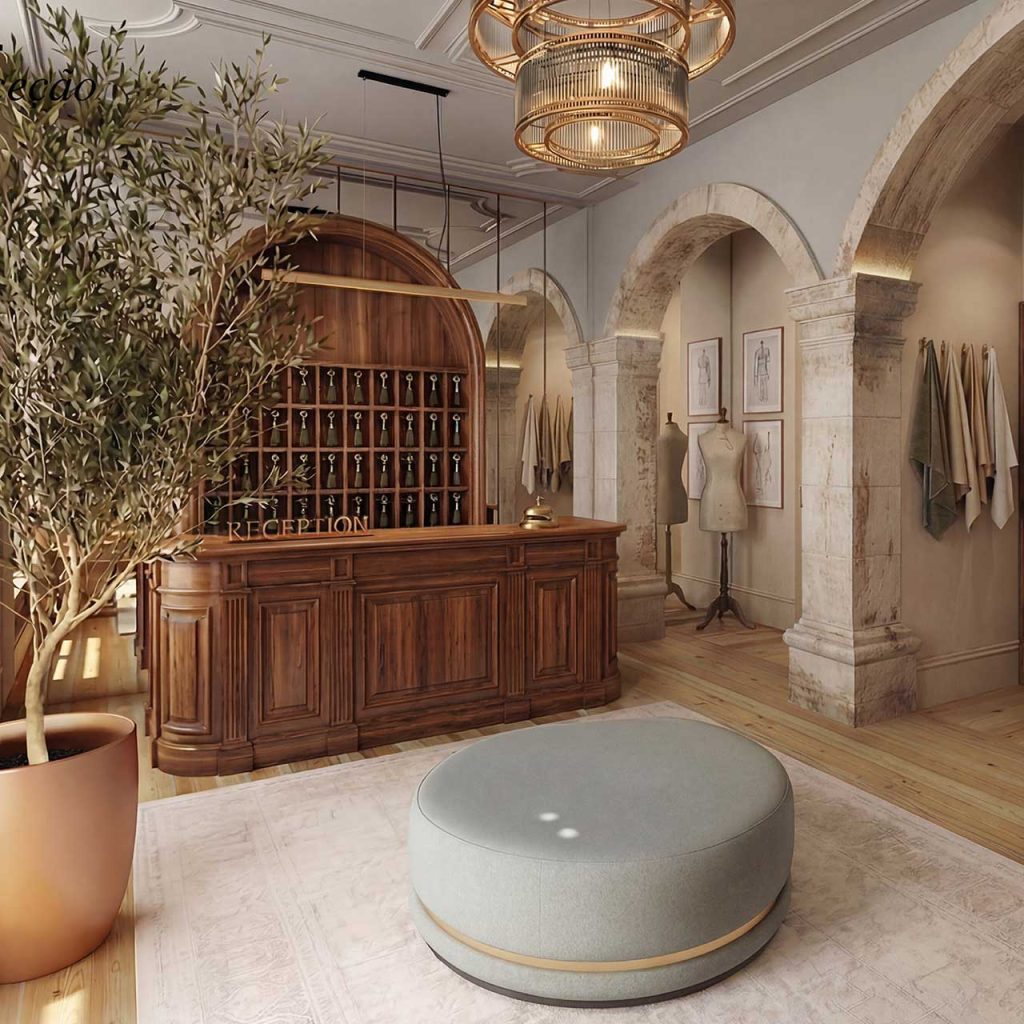 Wooden reception desk with wine rack backdrop in a boutique showroom, marble arches, and mannequins along a light-filled wall.